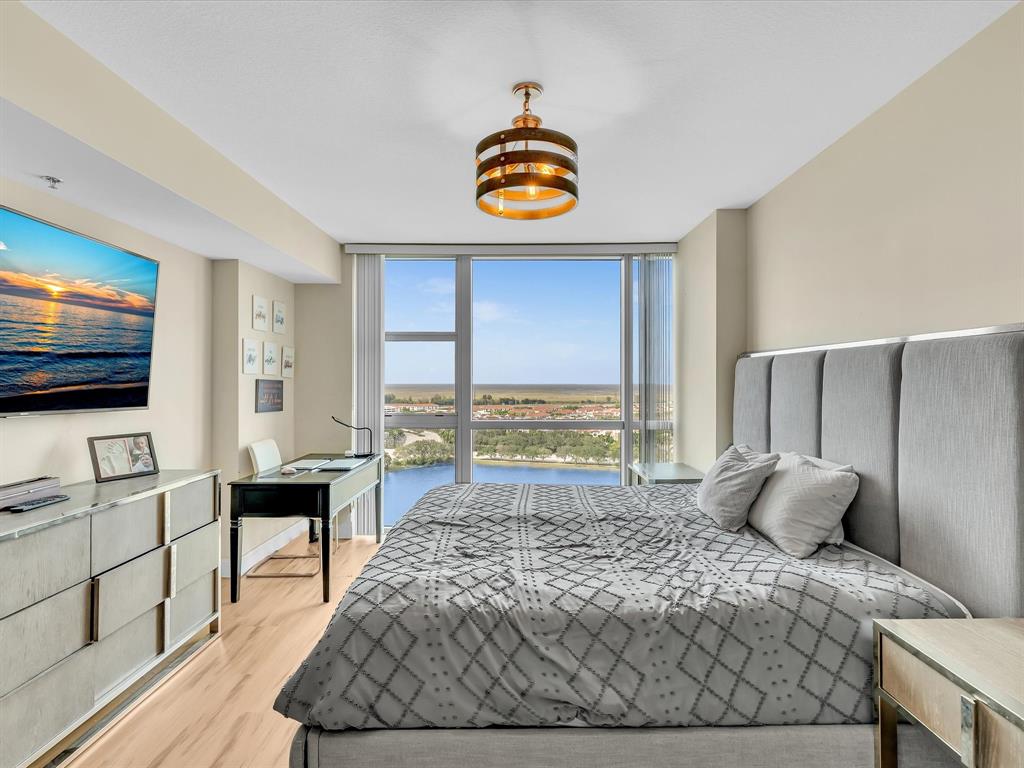 2681 North Flamingo Road, Unit 2104S Fort Lauderdale, FL 33323 - Photo 38 of 99 a bedroom with a bed and a flat screen tv