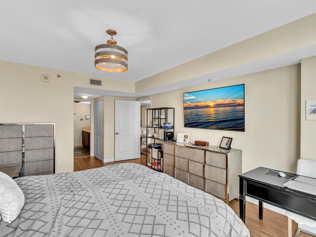 2681 North Flamingo Road, Unit 2104S Fort Lauderdale, FL 33323 - Photo 40 of 99 a bedroom with furniture and a flat screen tv