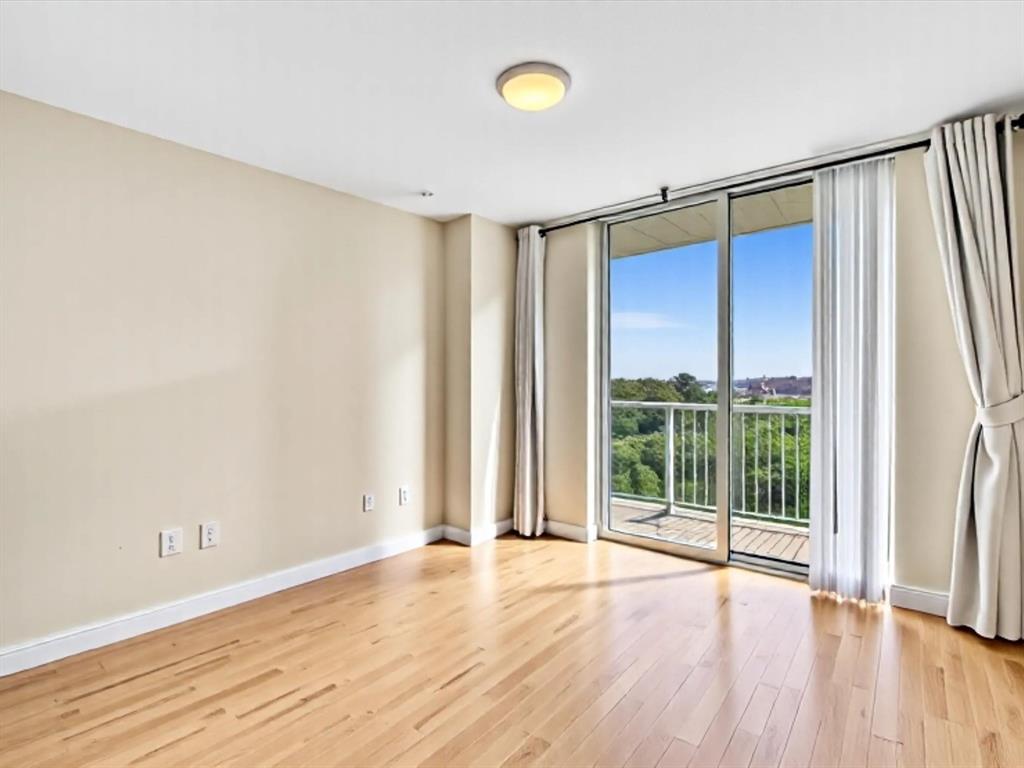 2681 North Flamingo Road, Unit 2104S Fort Lauderdale, FL 33323 - Photo 56 of 99 an empty room with wooden floor and sliding door