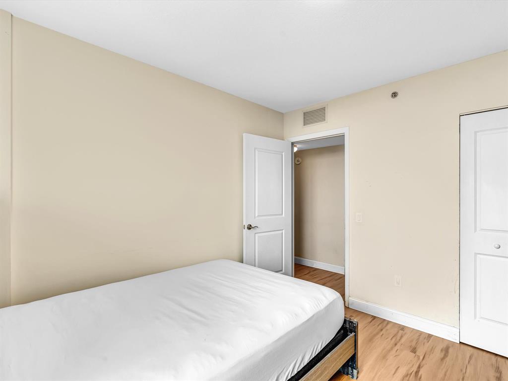 2681 North Flamingo Road, Unit 2104S Fort Lauderdale, FL 33323 - Photo 59 of 99 a bedroom with a bed and wooden floor