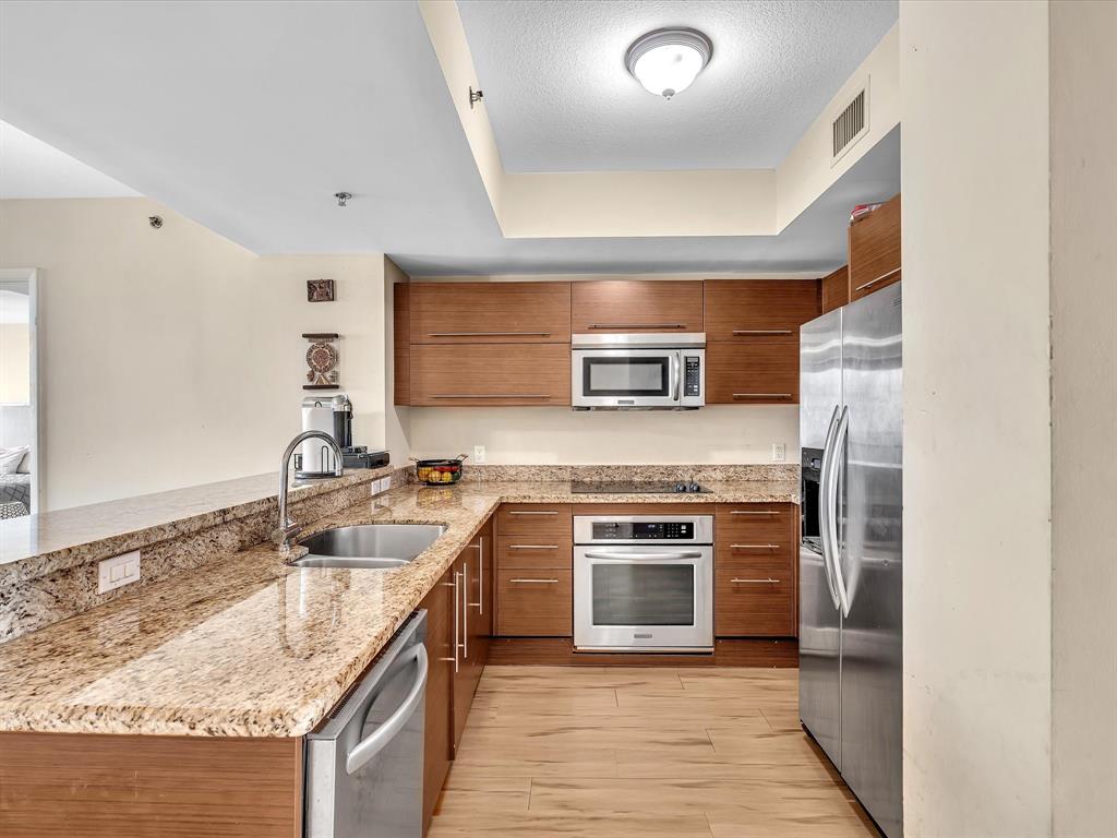 2681 North Flamingo Road, Unit 2104S Fort Lauderdale, FL 33323 - Photo 7 of 99 a kitchen with stainless steel appliances granite countertop a sink stove and refrigerator