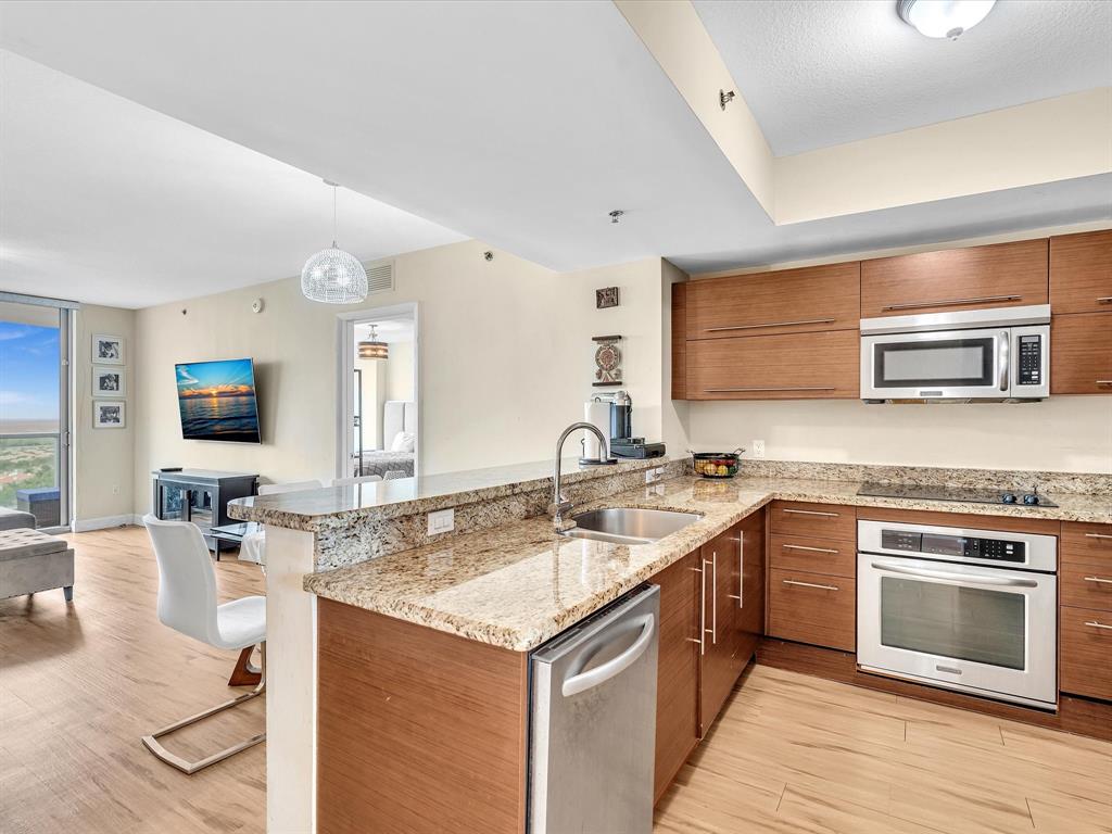 2681 North Flamingo Road, Unit 2104S Fort Lauderdale, FL 33323 - Photo 8 of 99 a kitchen with a sink stove and cabinets