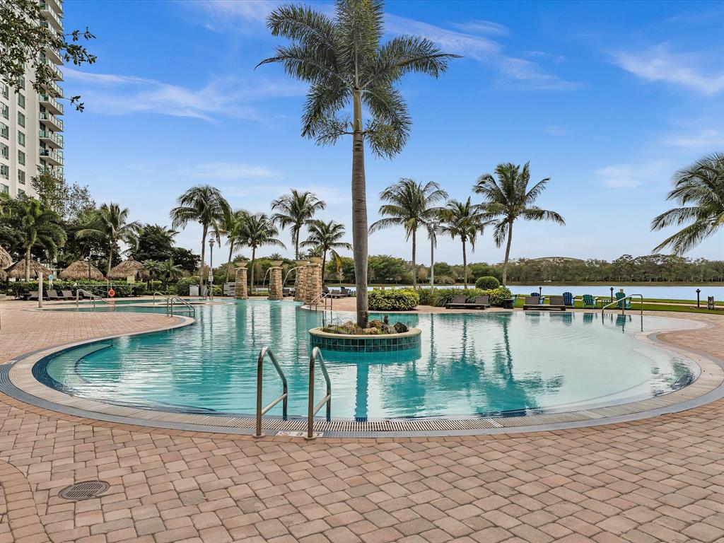 2681 North Flamingo Road, Unit 2104S Fort Lauderdale, FL 33323 - Photo 90 of 99 a view of swimming pool with a table and chairs
