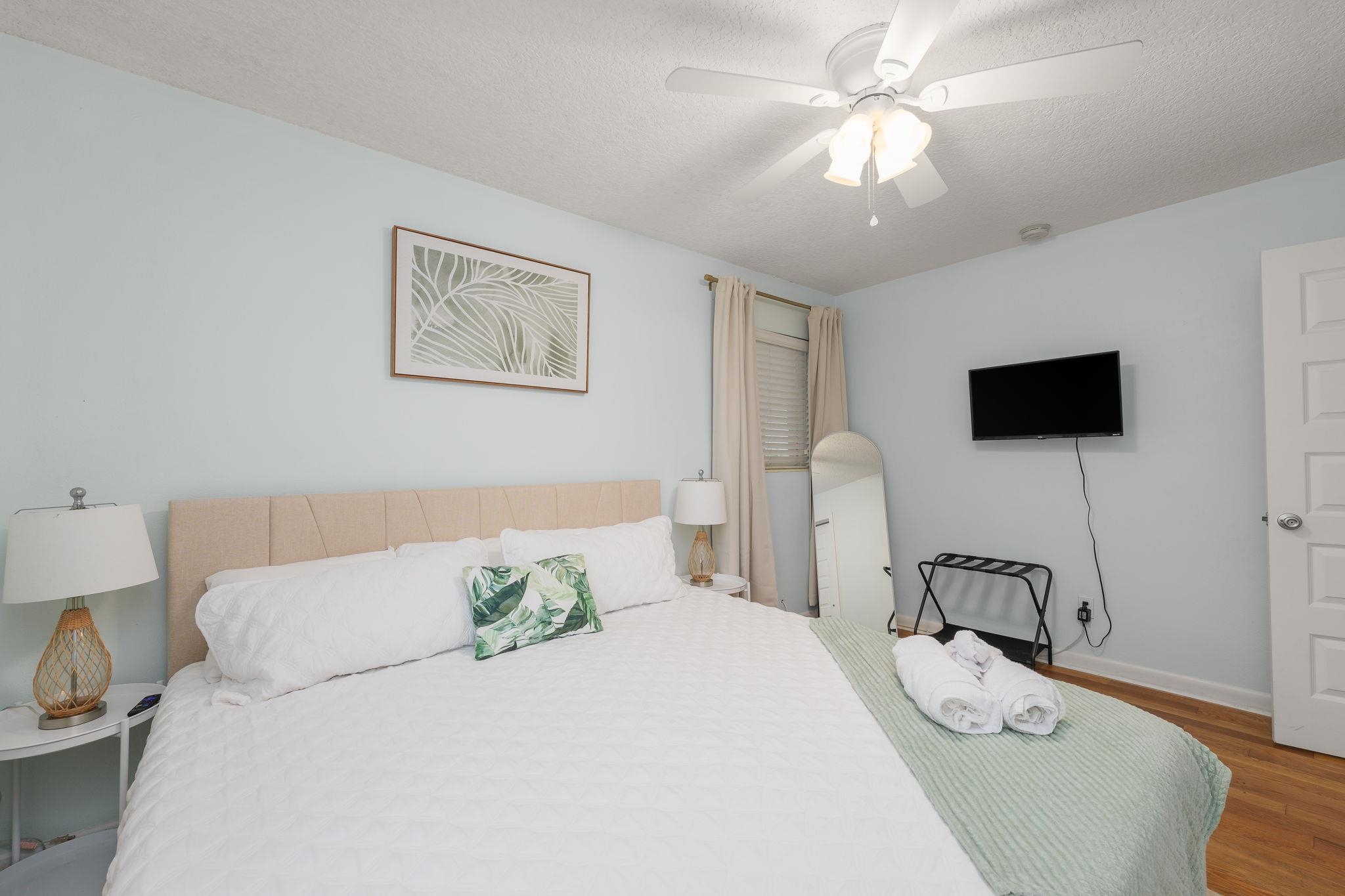 119 Menendez Road St. Augustine, FL 32080 - Photo 19 of 40 a bedroom with a bed and a flat tv screen on dresser