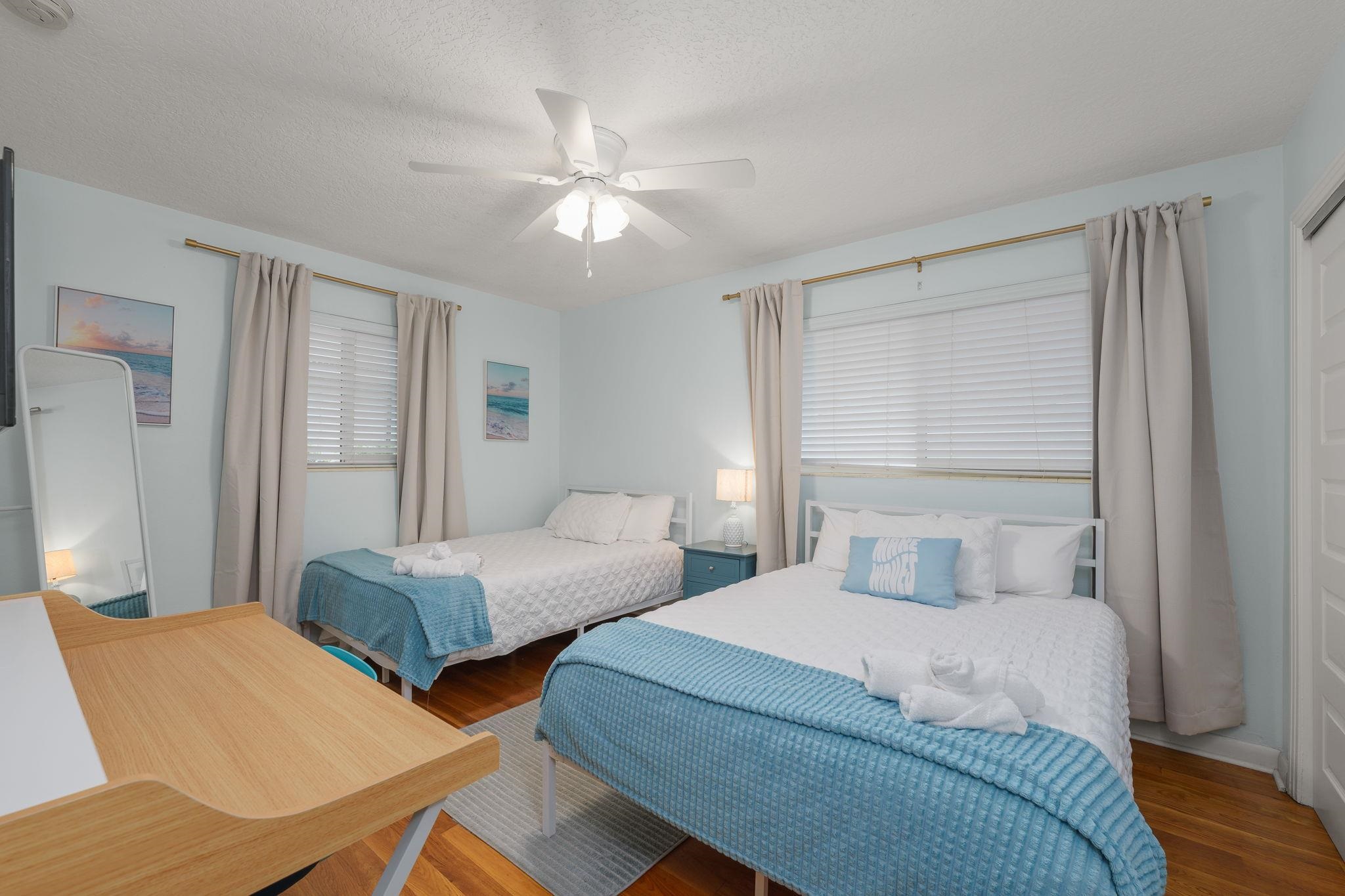 119 Menendez Road St. Augustine, FL 32080 - Photo 23 of 40 a bedroom with two beds and a chandelier