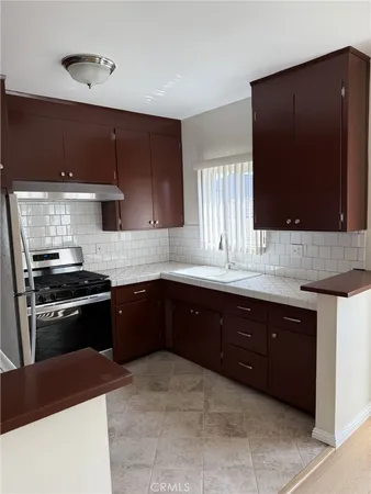 a kitchen with a sink and a stove