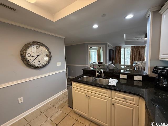 9994 Beach Club Drive, Unit 1204 Myrtle Beach, SC 29572 - Photo 18 of 36 Kitchen featuring a peninsula, crown molding, light tile patterned flooring, dark stone countertops, and recessed lighting