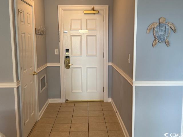 9994 Beach Club Drive, Unit 1204 Myrtle Beach, SC 29572 - Photo 3 of 36 Doorway to outside featuring tile patterned flooring and baseboards
