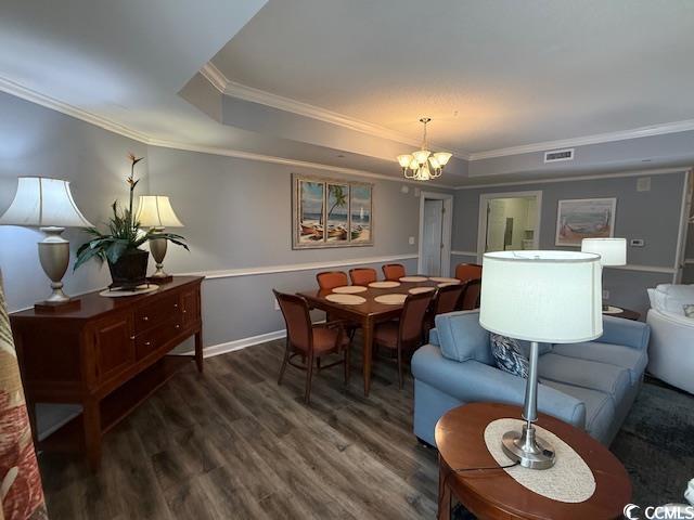 9994 Beach Club Drive, Unit 1204 Myrtle Beach, SC 29572 - Photo 5 of 36 Dining space with a raised ceiling, ornamental molding, wood finished floors, and a chandelier