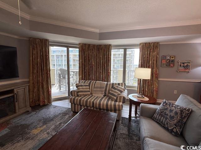 9994 Beach Club Drive, Unit 1204 Myrtle Beach, SC 29572 - Photo 7 of 36 Living room featuring ornamental molding, wood finished floors, and a textured ceiling