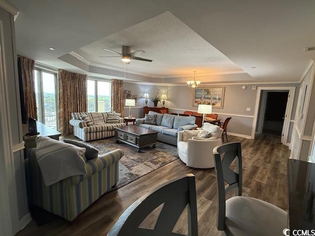 9994 Beach Club Drive, Unit 1204 Myrtle Beach, SC 29572 - Photo 8 of 36 Living room with a tray ceiling, a chandelier, wood finished floors, and ornamental molding