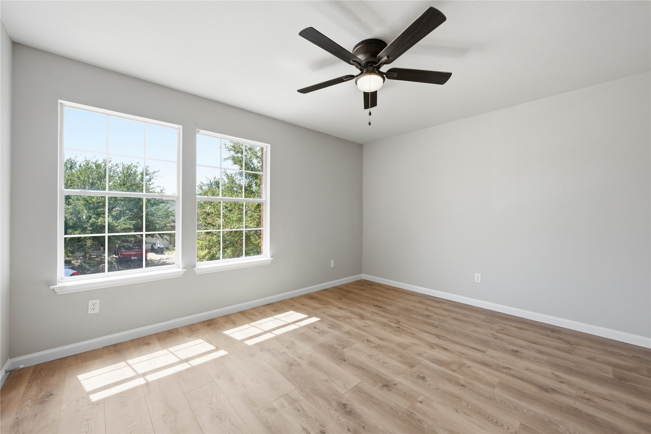 6917 Panda Royle Drive Del Valle, TX 78617 - Photo 20 of 23 Natural light floods this room, highlighting the clean lines and modern design of the light wood flooring.