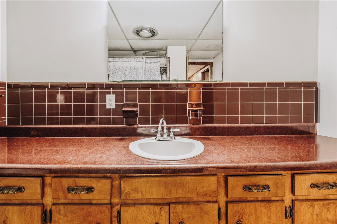 707 Campbell Town Road Walhalla, SC 29691 - Photo 32 of 44 A spacious vanity features wood cabinetry and a tiled backsplash.
