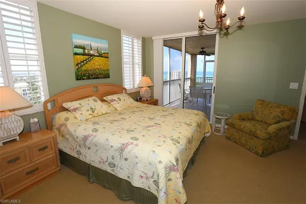 a bedroom with a bed dresser and a window