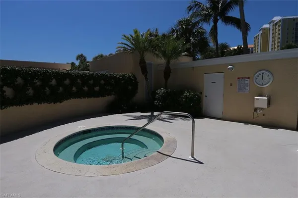 a small pool with some trees in the background