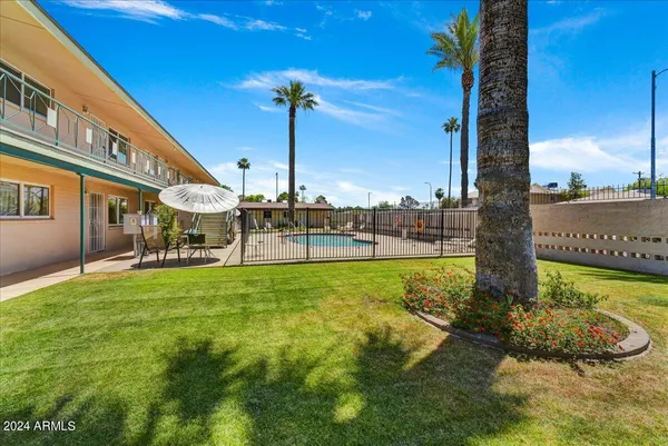 a swimming pool with outdoor seating and yard
