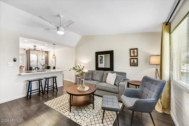 a living room with furniture a table and a window