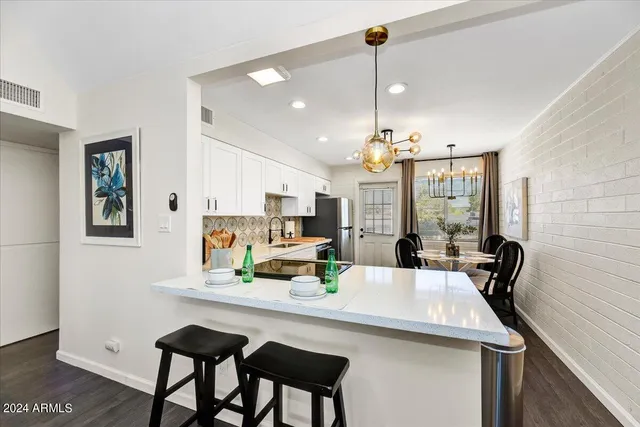 a view of a dining room with furniture and chandelier