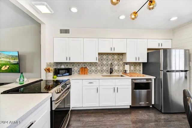 a kitchen with a white stove top oven and refrigerator