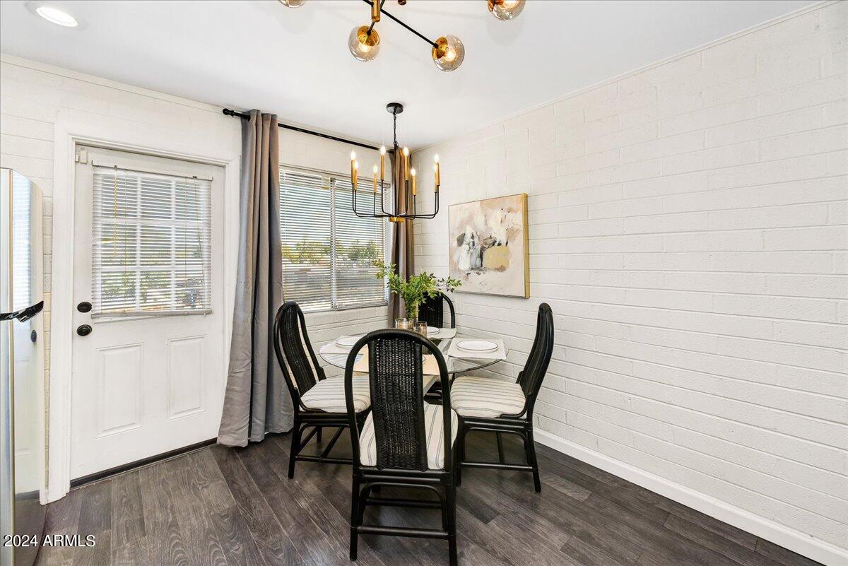 1908 West Berridge Lane, Unit 9 Phoenix, AZ 85015 - Photo 7 of 15 a view of a dining room with furniture window and wooden floor
