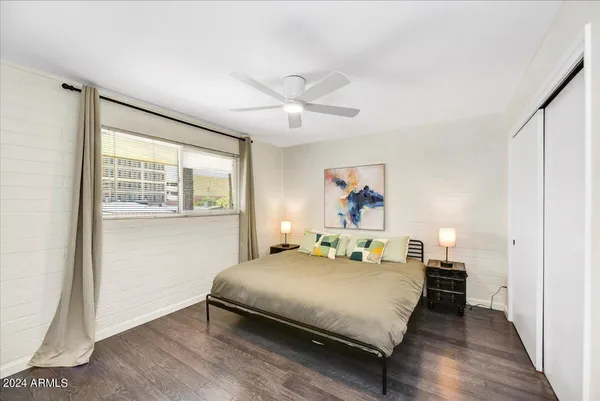 a bedroom with a bed and a large window