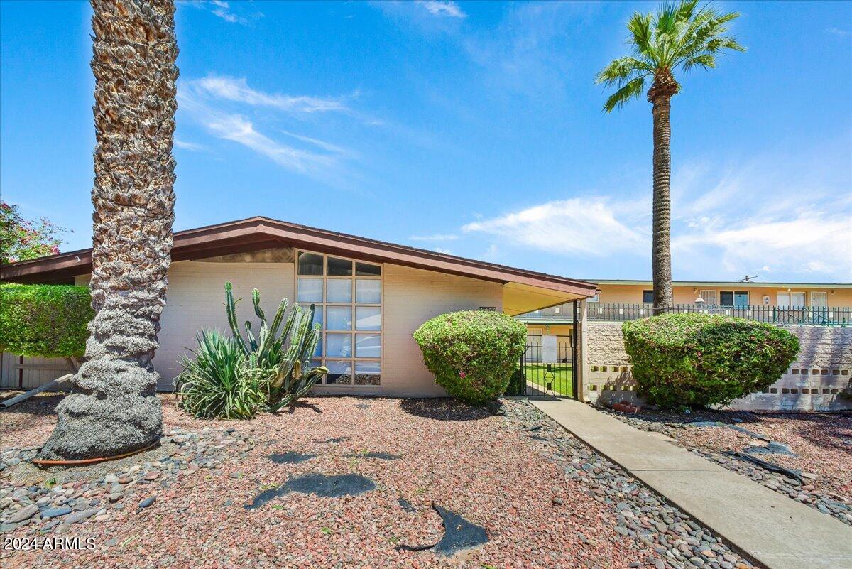 1908 West Berridge Lane, Unit 9 Phoenix, AZ 85015 - Photo 10 of 15 a front view of a house with garden