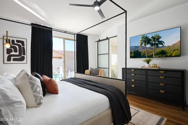 a bed sitting in a bedroom next to a lamp