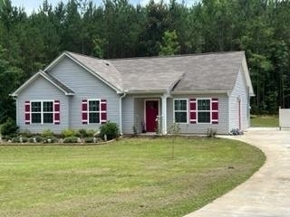 a view of a house with garden and yard