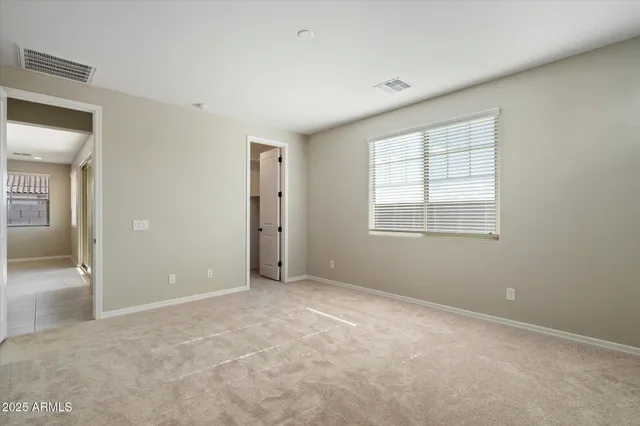 an empty room with windows and closet