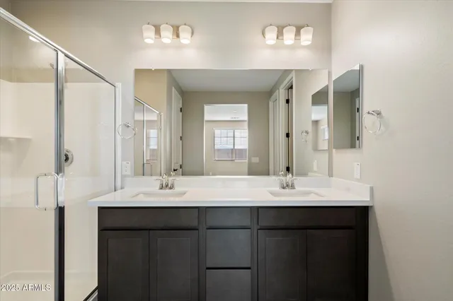 a bathroom with a double vanity sink and a mirror