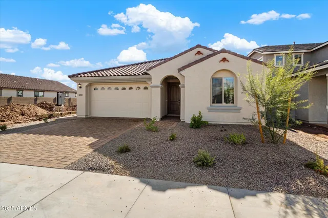 a view of a white house with a yard