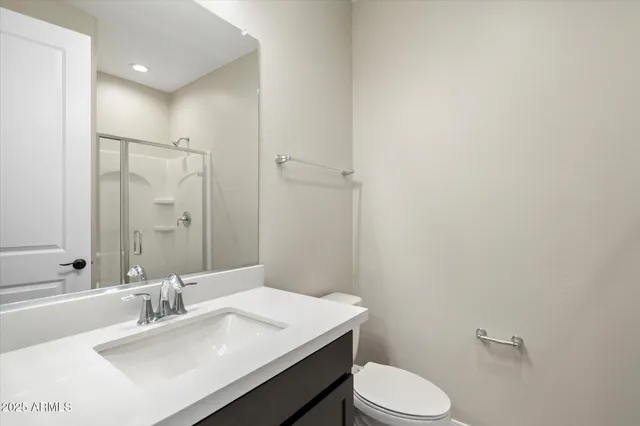 a bathroom with a glass shower door