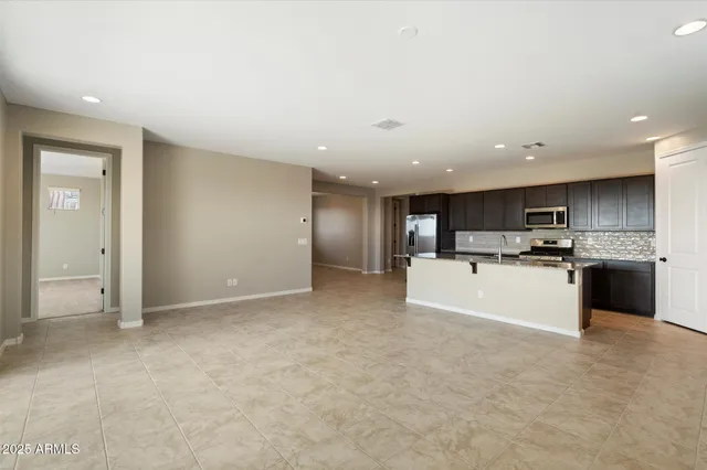 a view of kitchen with refrigerator and window
