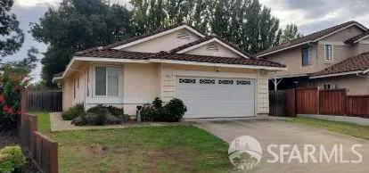 a front view of a house with a garden and yard