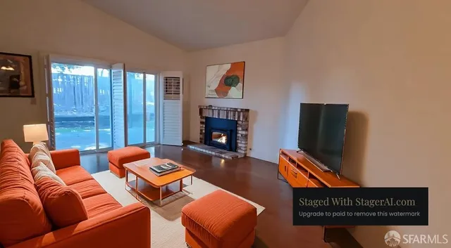 a living room with furniture a flat screen tv and a fireplace