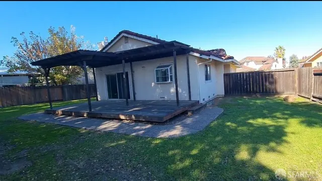 a backyard of a house with table and chairs