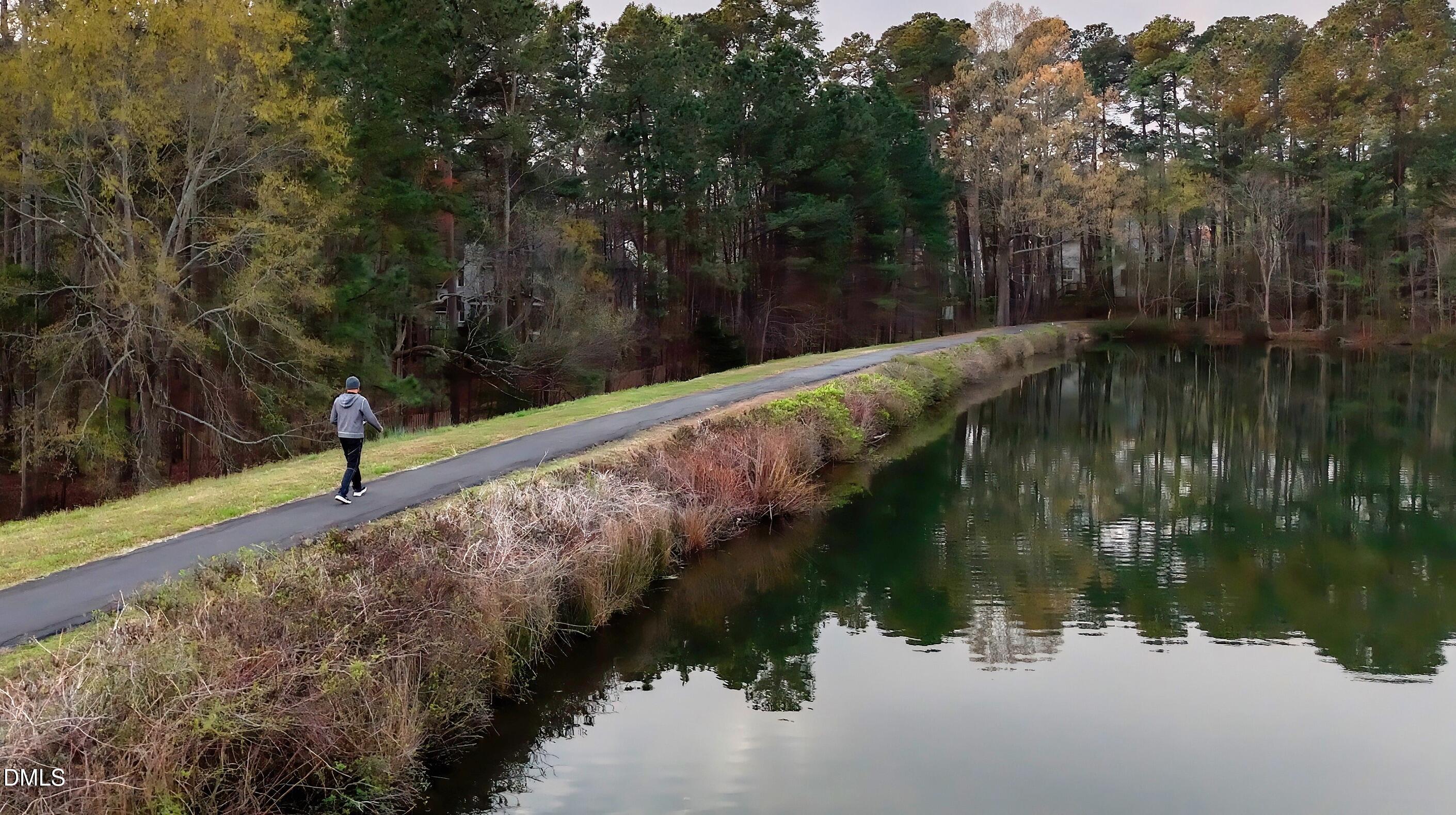 7 Monteith Court Durham, NC 27713 - Photo 2 of 44 a view of a lake with a yard and large trees