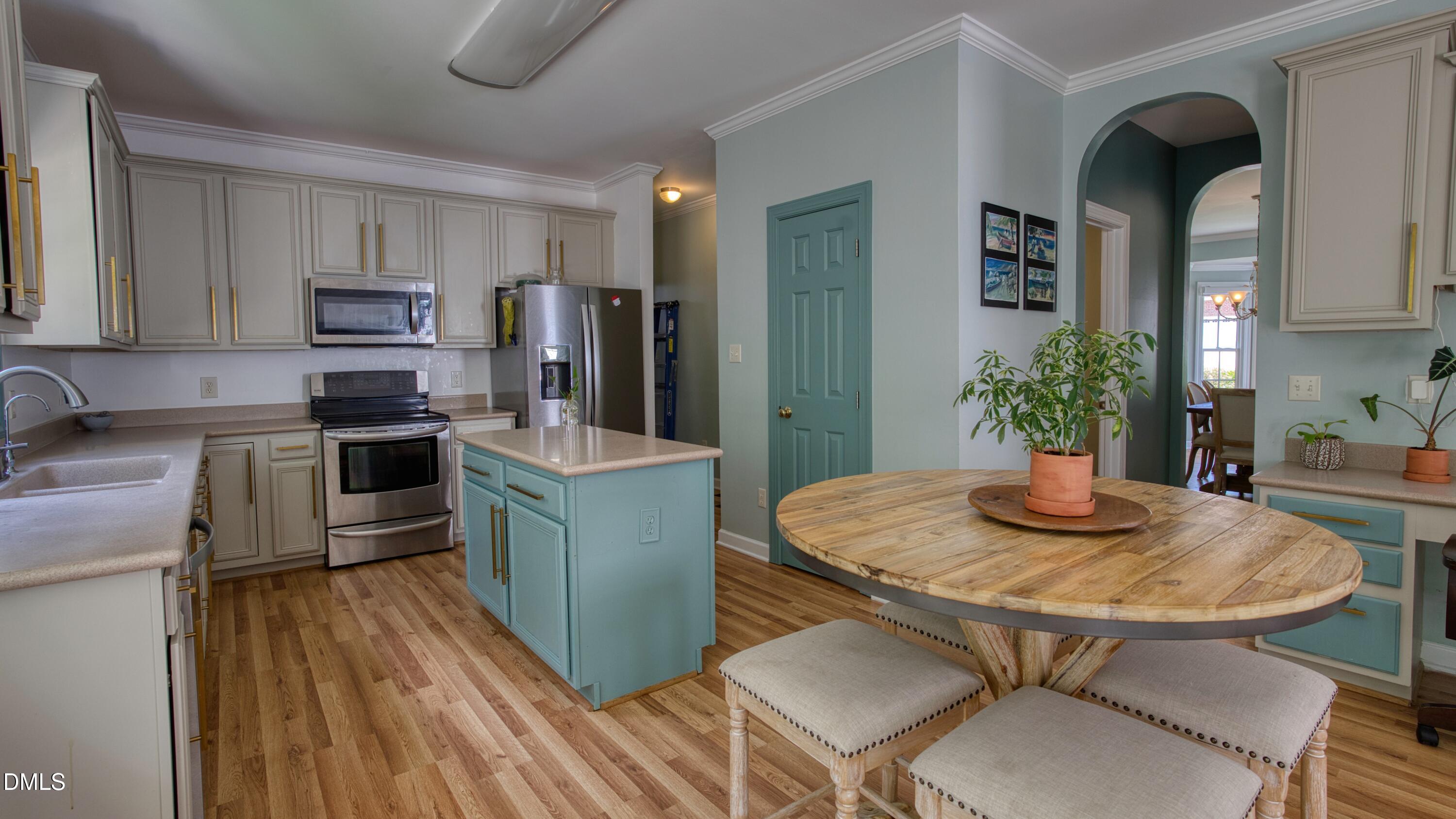 7 Monteith Court Durham, NC 27713 - Photo 26 of 44 a kitchen with stainless steel appliances granite countertop a stove a sink a refrigerator and a dining table