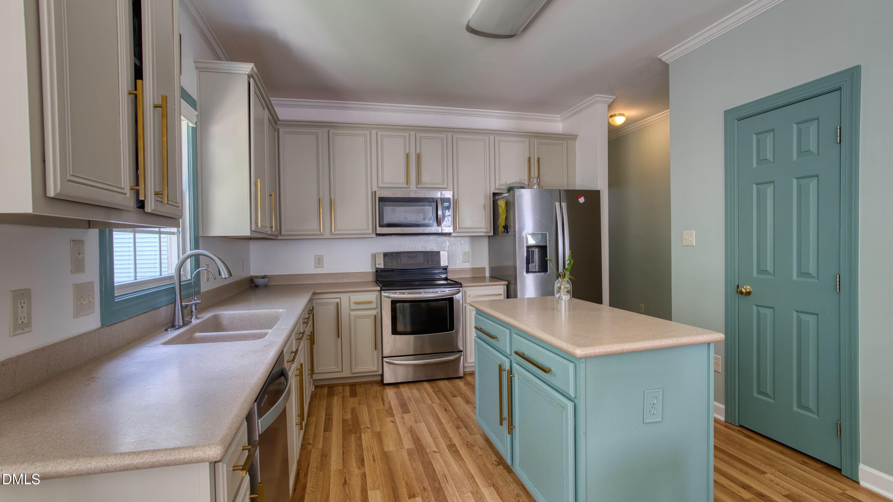 7 Monteith Court Durham, NC 27713 - Photo 29 of 44 a kitchen with a refrigerator stove and sink