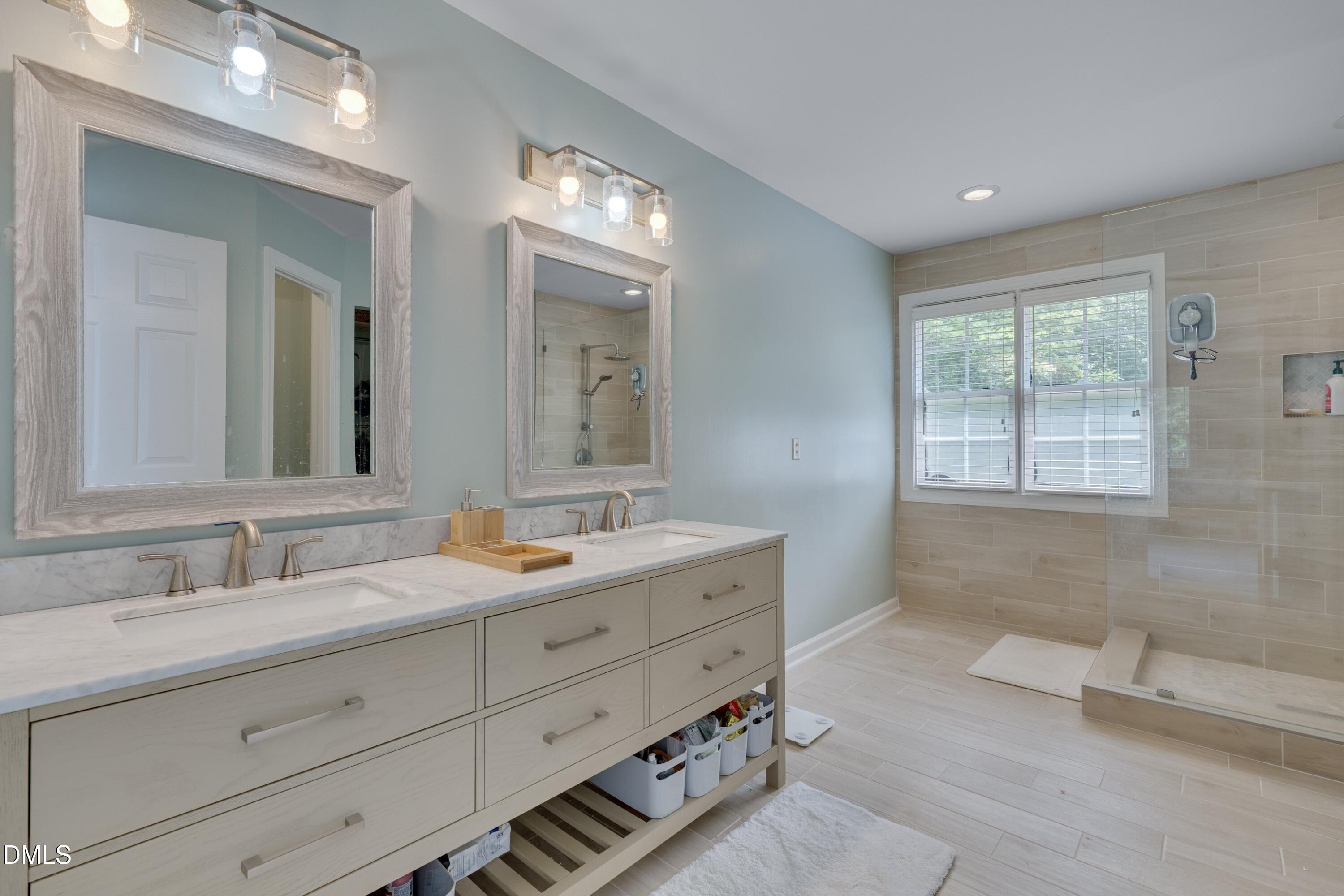 7 Monteith Court Durham, NC 27713 - Photo 33 of 44 a bathroom with double vanity sink a mirror and a bathtub