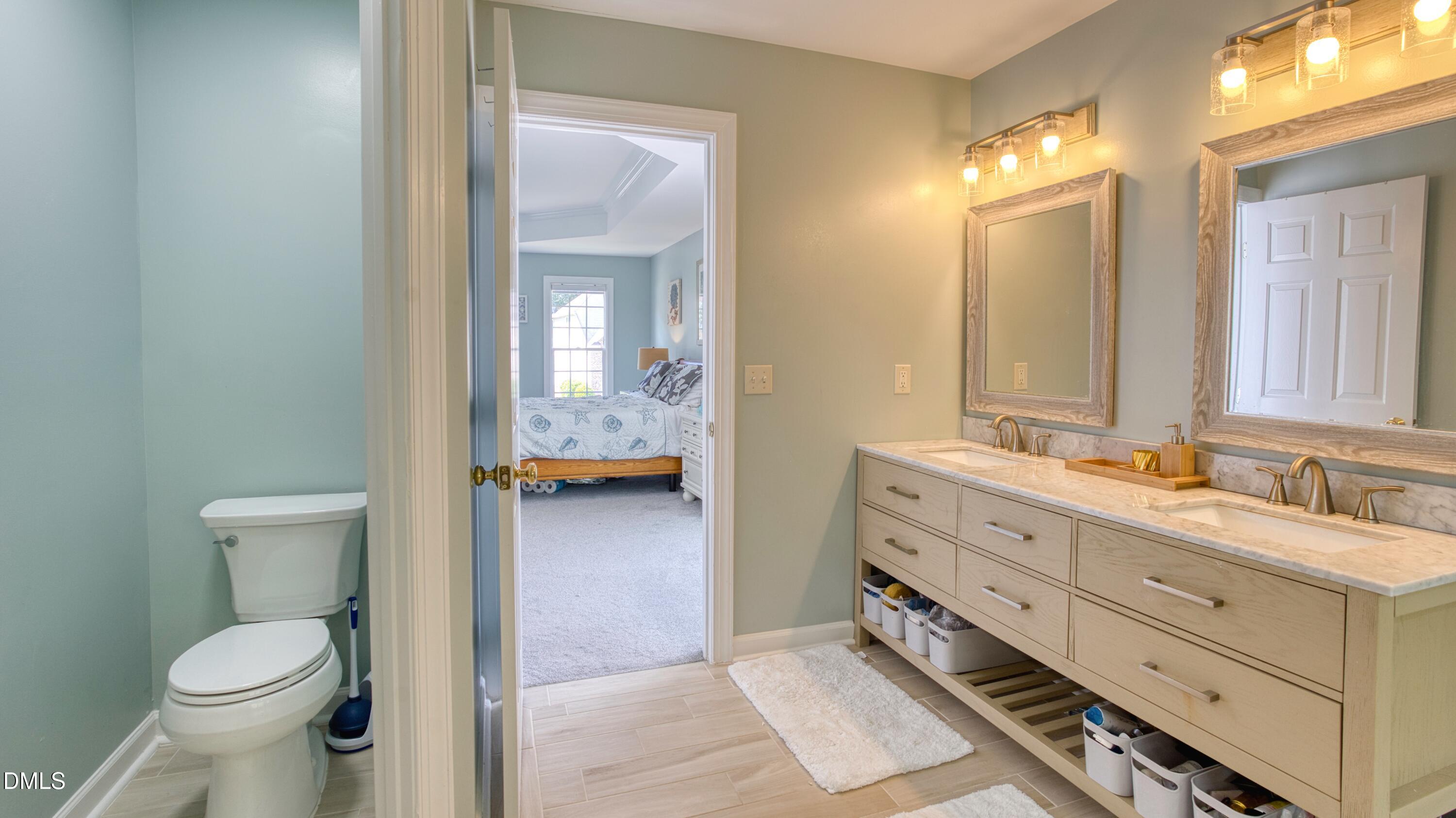 7 Monteith Court Durham, NC 27713 - Photo 37 of 44 a bathroom with a toilet sink and mirror