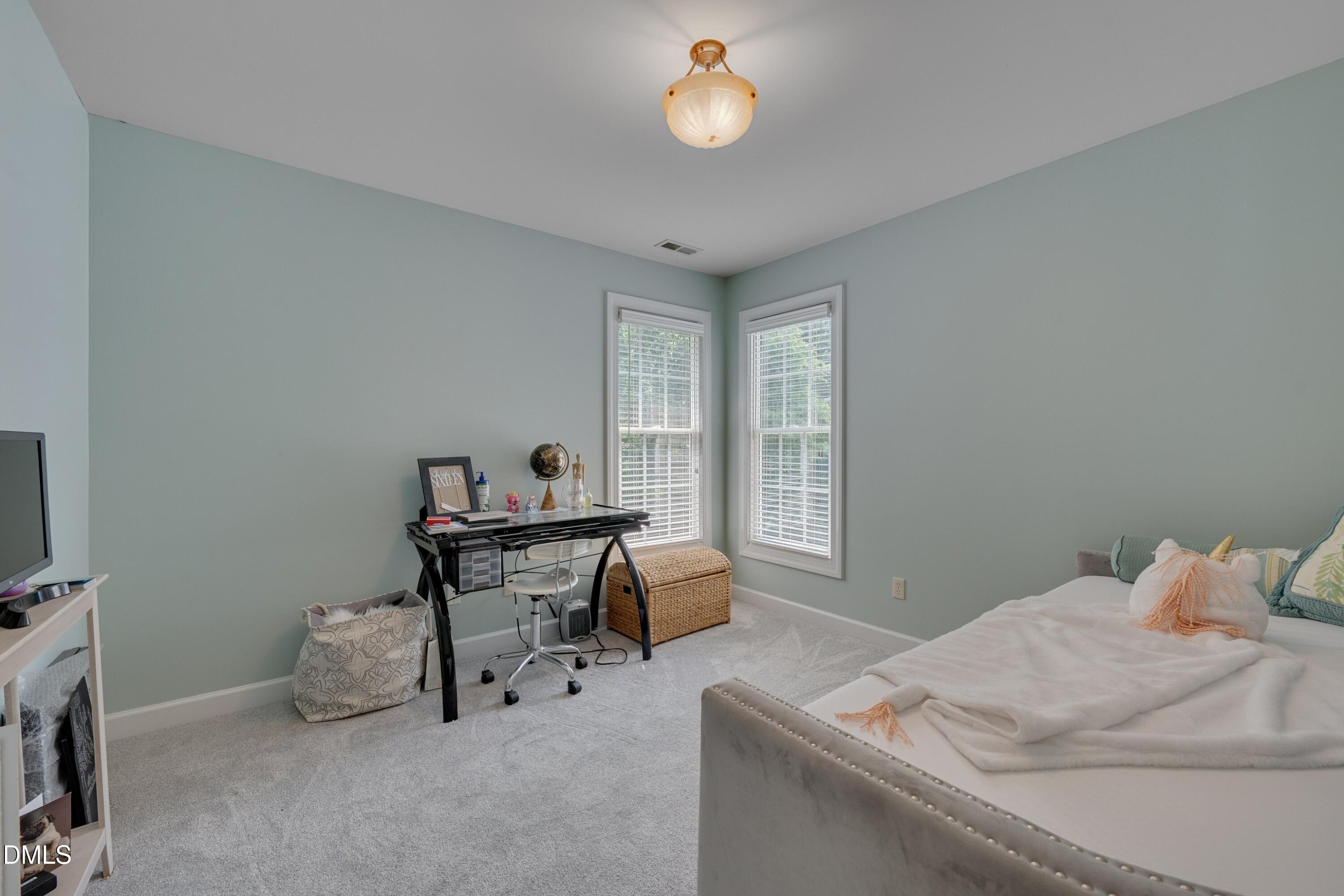 7 Monteith Court Durham, NC 27713 - Photo 42 of 44 a bedroom with a bed and a table in it