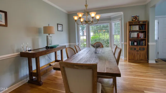 a dining room with furniture and chandelier