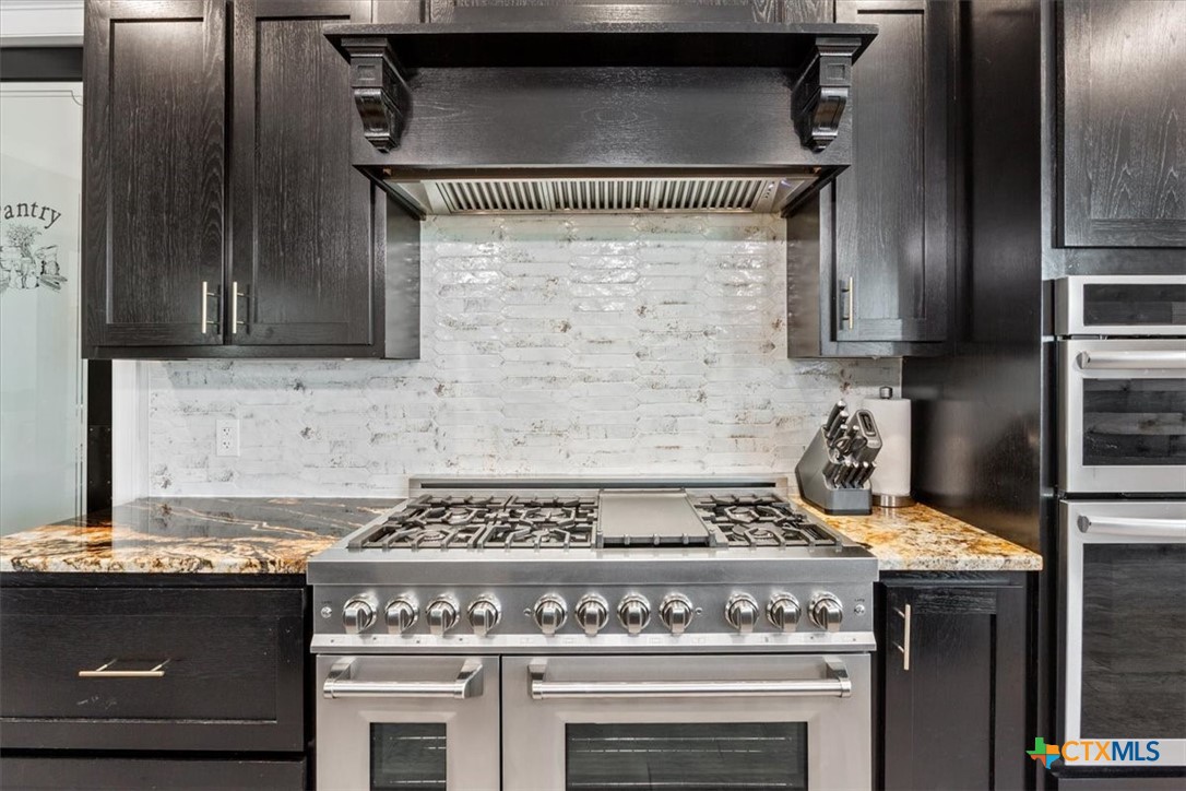 10940 Wedel Cemetery Road Rogers, TX 76569 - Photo 10 of 48 a stove top oven sitting inside of a kitchen