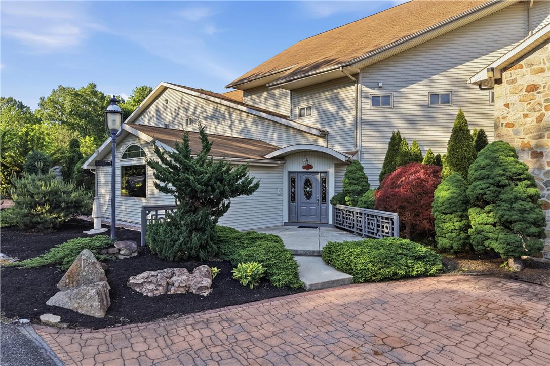 6271 Batman Road Zionsville, PA 18092 - Photo 3 of 100 A graceful entry welcomes guests with intricate door detailing and lush, mature landscaping.