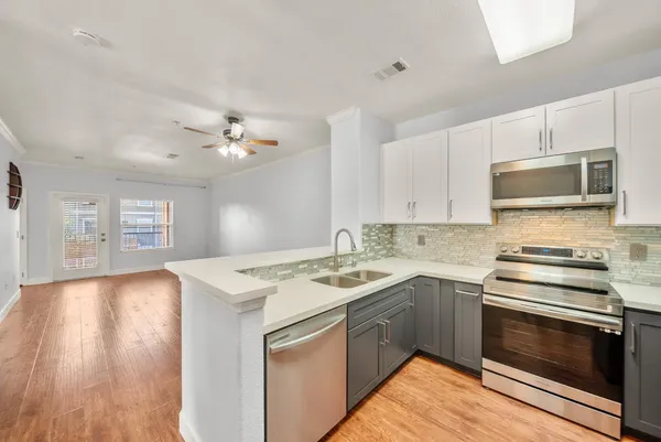 a kitchen with a stove a sink and a microwave