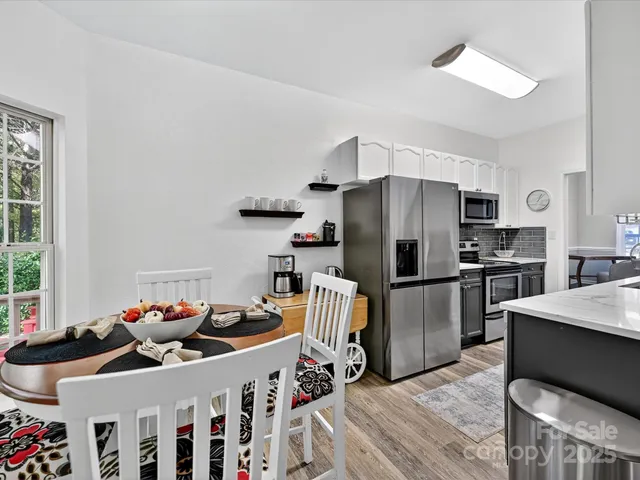 a kitchen with stainless steel appliances a refrigerator and a stove top oven