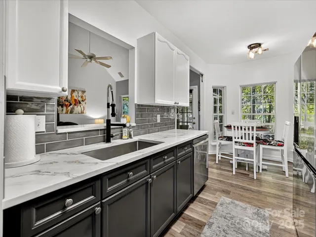 a kitchen with counter top space cabinets and wooden floor