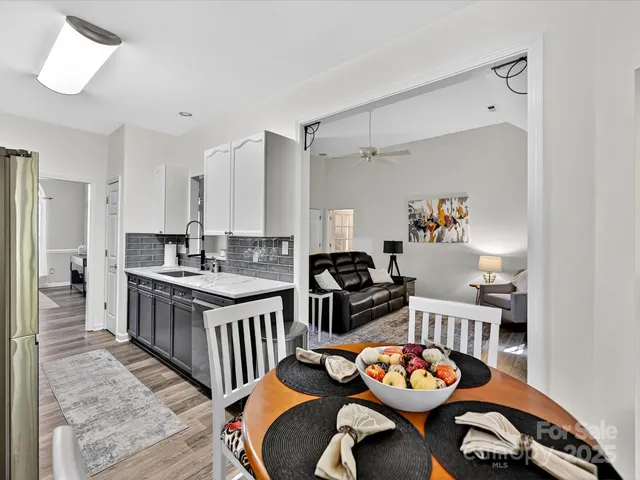 a kitchen with stainless steel appliances granite countertop a stove and a dining table