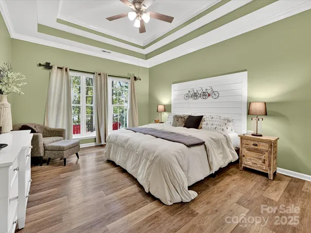 a bedroom with a large bed and a chandelier